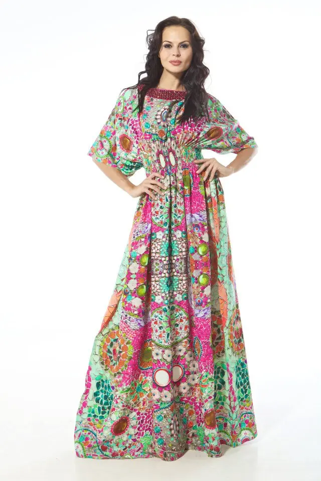 This long, thobe-like dress is made from fluid silk jersey, printed in a high-contrast, exaggerated ikat pattern. The silhouette includes full sleeves and a right-side slit that runs up to the hem, revealing a subtle layered construction beneath. The top layer wraps across the body, creating natural drape and asymmetry that shifts with movement. The combination of traditional ikat inspiration and contemporary construction reflects Resort 2013’s exploration of surface design and layered form, balancing bold print with a soft, architectural flow.